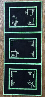 Black placemats with bamboo embroidery.