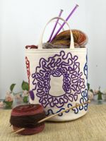 Canvas basket with embroidery of cats tangled in yarn