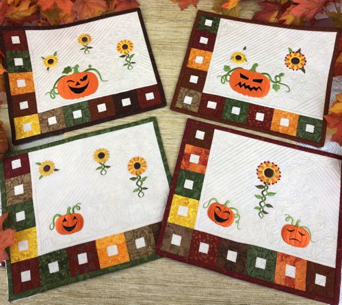 4 placemats in Fall colors with embroidered sunflowers and Jack-O-Lanterns,