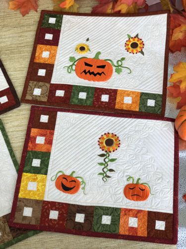 2 placemats in Fall colors with embroidered sunflowers and Jack-O-Lanterns,