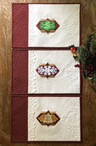 3 quilted placemats with Christmas-themed applique