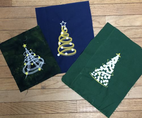 3 test stitch-outs of the Christmas trees.