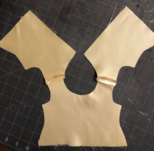 The top parts stitched at shoulders.