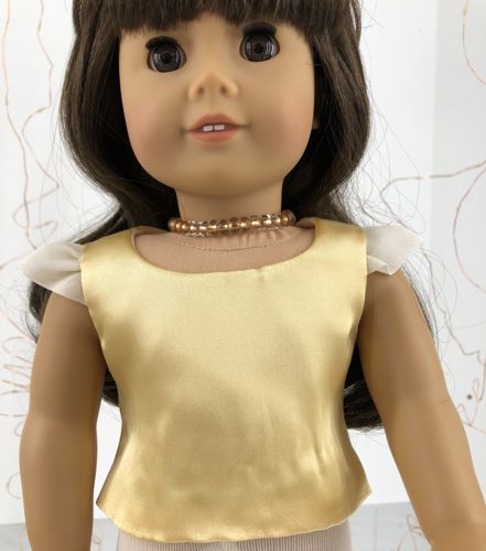 The blouse on the doll.