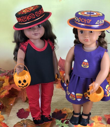 2 dolls in finished boater hats with embroidery on tops of the hats.