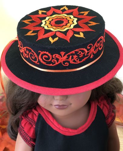 A doll in a black boater hat.