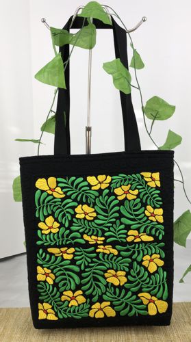 Finished tote bag with embroidery of bright yellow flowers and green leaves on the front panel.