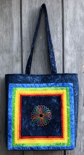 Finished tote bag with embroidery of 6-color geometric design on the front panel.