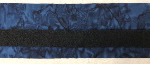 The batting strip is positioned over the fabric strip.