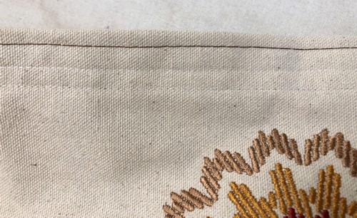 topstitch along the upper edge of the canvas bag, 1/4" from the edge.