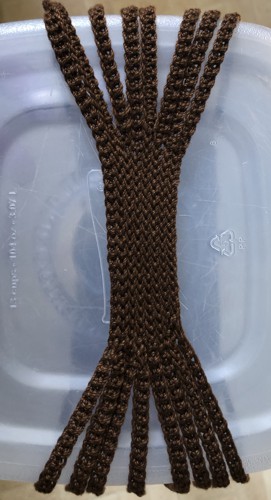 The middle part of the handle is shaped by stips connected together with slip stitches.