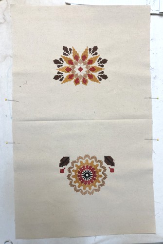 Stitch-outs of the Sothwestern Flower motifs on the canvas.