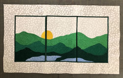 Three stitch-outs of the mountains are stiched together to make a panaramic landscape.