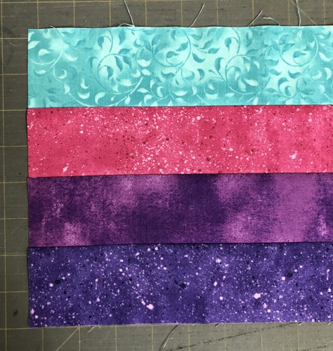 4 colored strips are sewn together along the long edges.