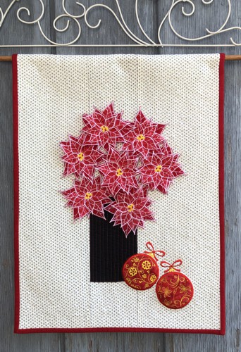 A light-colored quilt with 3D poinsettia flowers and Christmas balls applique