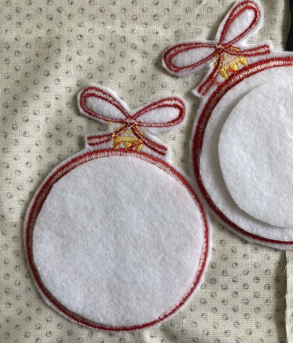 Out of the felt, cut 2 circles 1/4" smaller than the stitch-out.