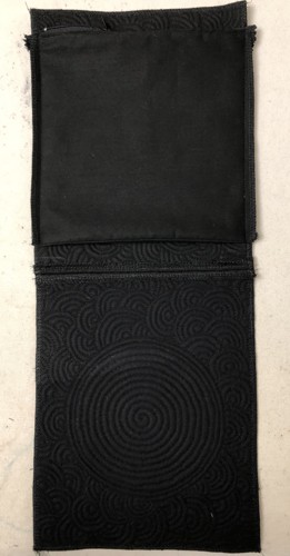 The pocket stitched to the back panel.