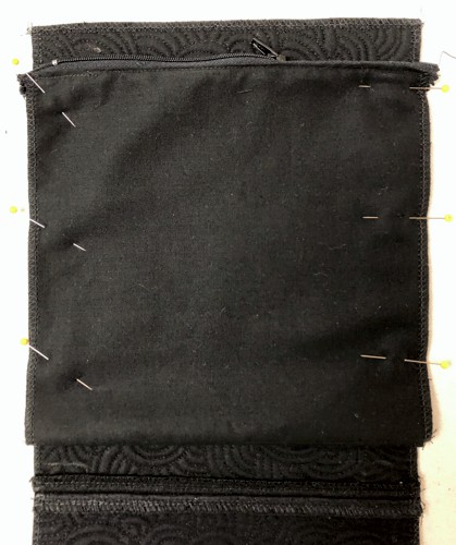 The pocket pinned to the back panel.