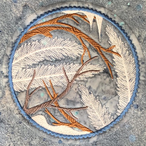 A close up of Winter Window embroidery.