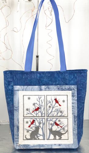 Finished tote bag with embroidery of panes with cats, birds and branches on the front panel.